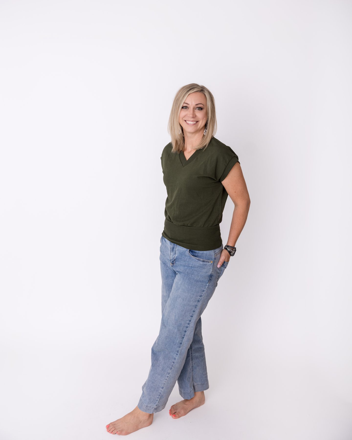 Christina, founder of Alchemy of Healing, standing in a softly lit studio