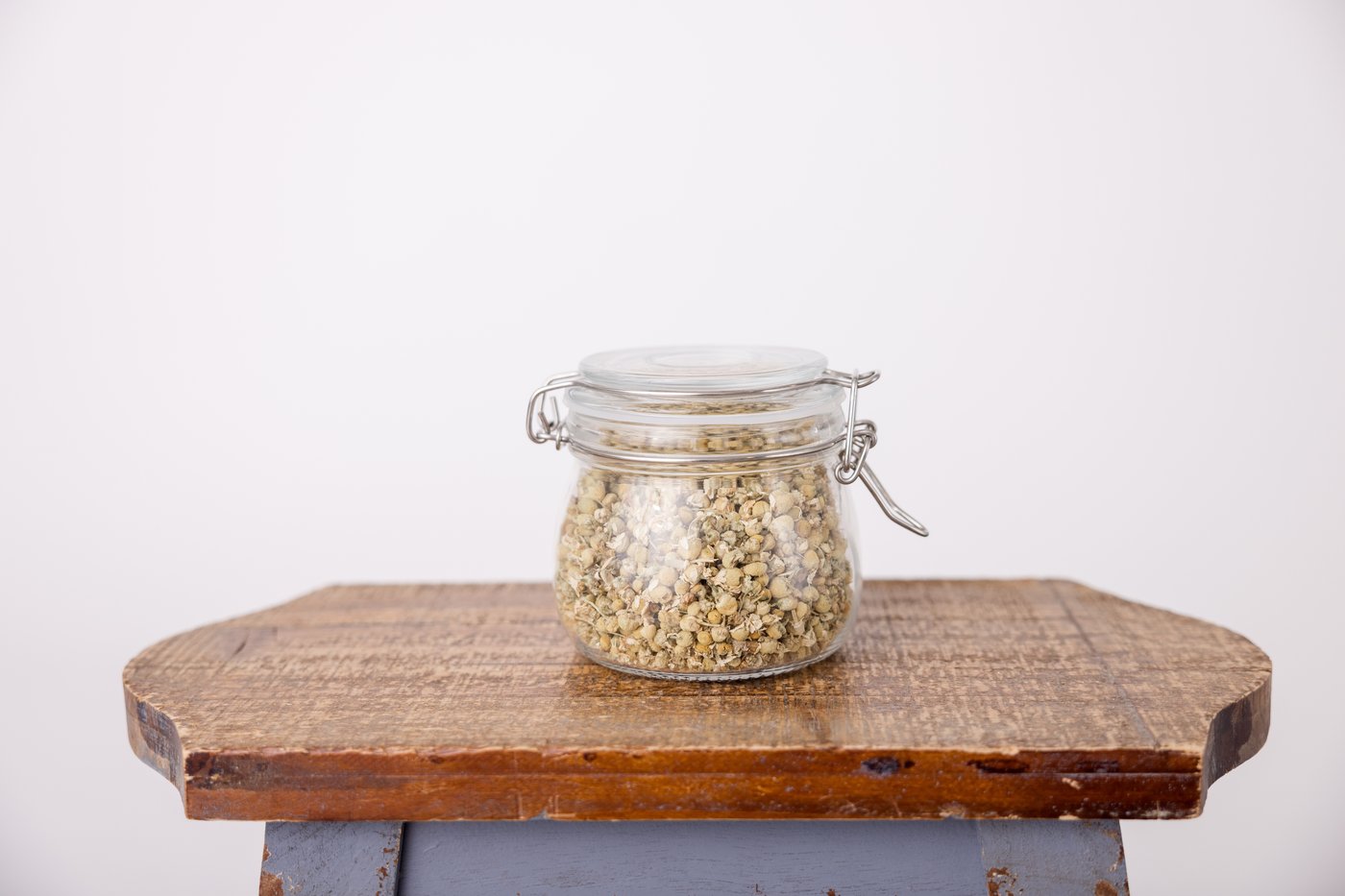 Jar of dried chamomile used in herbal practice